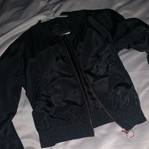 Black track jacket with rose gold zipper